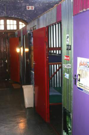 A novel place: the shell of a building that had once been a Victorian pumping station.  The rooms/cells were in a cavernous part of the building and their walls were made of corrugated iron, metal doors and reed ceilings.
