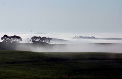 In the distance, mist made milky lakes in the valleys and hollows.